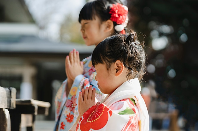 祈る和服の幼い姉妹